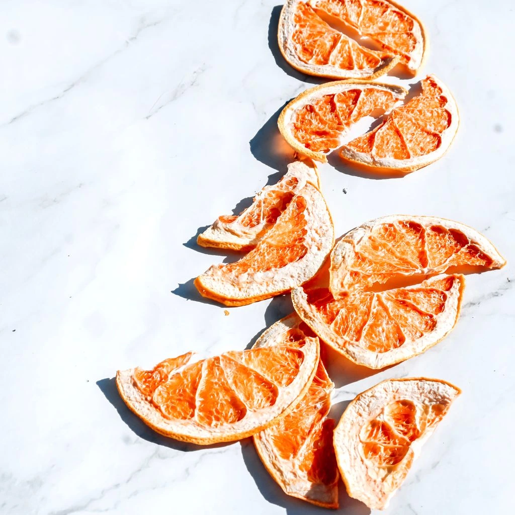Raw dehydrated snacks in ceramic bowls on linen